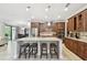 Modern kitchen featuring a large island with barstools, stainless steel appliances, and custom cabinetry at 11624 Calf Path Dr, Tampa, FL 33626