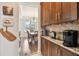 Gourmet coffee bar area with custom cabinets and granite countertops, perfect for entertaining guests at 11624 Calf Path Dr, Tampa, FL 33626