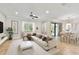 Open-concept living room and dining area with neutral decor and sliding glass doors to the outdoor area at 11624 Calf Path Dr, Tampa, FL 33626