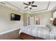 Beautiful primary bedroom features hardwood floors, tray ceiling, ceiling fan, decorative windows and tv at 11624 Calf Path Dr, Tampa, FL 33626