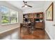 Bright office space with hardwood floors, a built-in bookcase, and a large window for natural light at 11624 Calf Path Dr, Tampa, FL 33626