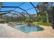 Gorgeous screened pool with spa, travertine deck, and natural surroundings at 11624 Calf Path Dr, Tampa, FL 33626