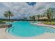 Inviting outdoor pool area with sun loungers, palm trees, and clear blue water, perfect for relaxation and recreation at 11624 Calf Path Dr, Tampa, FL 33626
