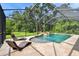 Inviting screened pool with attached spa and ample seating for outdoor relaxation at 11624 Calf Path Dr, Tampa, FL 33626