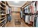 A spacious walk-in closet features custom shelving, drawers, and clothing racks to keep you organized at 11624 Calf Path Dr, Tampa, FL 33626