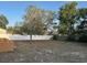 Expansive backyard features mature trees, grass, and a privacy fence at 12230 Skyler Ln, Spring Hill, FL 34609