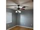 Cozy bedroom featuring a ceiling fan, a window for natural light, and neutral wall color at 12230 Skyler Ln, Spring Hill, FL 34609