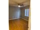 Bright bedroom featuring a ceiling fan, a window for natural light, and neutral wall color at 12230 Skyler Ln, Spring Hill, FL 34609