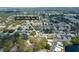 The aerial view shows the property nestled among lush trees and a serene lake at 12913 126Th Ter, Largo, FL 33774