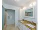 Bright bathroom with dual sinks, granite countertop, large mirror, and walk-in shower at 12913 126Th Ter, Largo, FL 33774