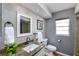 Well-lit bathroom featuring a granite countertop, a white framed mirror, and neutral tile at 12913 126Th Ter, Largo, FL 33774