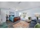 Bright bedroom with a window seat, hardwood floors, and a comfortable seating area at 12913 126Th Ter, Largo, FL 33774