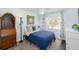 Well-lit bedroom with a wooden hutch, a blue bedspread, and ample natural light at 12913 126Th Ter, Largo, FL 33774