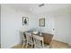 Simple dining room with a table, six chairs, white walls and tile floor at 12913 126Th Ter, Largo, FL 33774