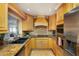 Well-equipped kitchen with stainless steel appliances and lots of wood cabinets at 12913 126Th Ter, Largo, FL 33774