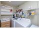 Functional laundry room with washer, dryer, shelving, and cabinet at 12913 126Th Ter, Largo, FL 33774