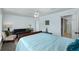 Relax in this comfortable bedroom with fresh light, seating area, ceiling fan and ensuite bath at 12913 126Th Ter, Largo, FL 33774