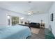 Spacious bedroom boasts a bay window, ceiling fan, and a seating area with a comfortable couch at 12913 126Th Ter, Largo, FL 33774