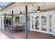 Inviting patio area with a brick floor, ceiling fans, and views of the pool at 12913 126Th Ter, Largo, FL 33774