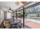 Spacious screened-in patio with ceiling fans, and views of the pool and backyard at 12913 126Th Ter, Largo, FL 33774