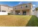 Exterior view of the backyard, featuring a well-maintained lawn and patio area at 13174 Royal Pines Ave, Riverview, FL 33579