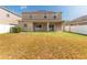 View of the backyard featuring a lawn, patio, and the back of the home at 13174 Royal Pines Ave, Riverview, FL 33579