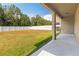 A spacious backyard featuring a large lawn, white fence, and covered patio at 13174 Royal Pines Ave, Riverview, FL 33579