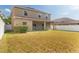 Exterior view of the backyard, showcasing a spacious lawn and covered patio at 13174 Royal Pines Ave, Riverview, FL 33579