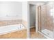 Bathroom featuring soaking tub and tiled walk-in shower at 13174 Royal Pines Ave, Riverview, FL 33579