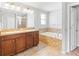 Bathroom featuring a large soaking tub, double vanity, and neutral tiling at 13174 Royal Pines Ave, Riverview, FL 33579