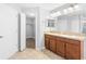 Bathroom with dual sinks, walk-in closet, and neutral colors at 13174 Royal Pines Ave, Riverview, FL 33579