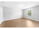 Bedroom with light gray walls, light wood floors, and window at 13174 Royal Pines Ave, Riverview, FL 33579