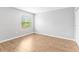 Well-lit bedroom featuring laminate flooring and a window at 13174 Royal Pines Ave, Riverview, FL 33579