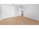 Comfortable bedroom with closet, wood-look floors, and neutral tones at 13174 Royal Pines Ave, Riverview, FL 33579