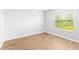 Bright bedroom featuring new flooring and a large window with natural light at 13174 Royal Pines Ave, Riverview, FL 33579