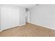 Comfortable bedroom with closet, wood-look floors, and neutral tones at 13174 Royal Pines Ave, Riverview, FL 33579