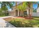Inviting two-story home with a two-car garage and lush tropical landscaping at 13174 Royal Pines Ave, Riverview, FL 33579
