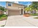 Two story home with a neutral color scheme, a large driveway and lawn at 13174 Royal Pines Ave, Riverview, FL 33579