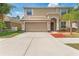 Two story home with a neutral color scheme and a large driveway at 13174 Royal Pines Ave, Riverview, FL 33579
