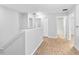 Upstairs hallway with wood-look floors and neutral paint at 13174 Royal Pines Ave, Riverview, FL 33579