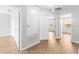 Bright hallway with wood-look floors leading to bedrooms and bathrooms at 13174 Royal Pines Ave, Riverview, FL 33579