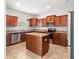 Well-equipped kitchen features stainless steel appliances, a center island, and granite countertops at 13174 Royal Pines Ave, Riverview, FL 33579