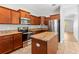 Spacious kitchen boasts granite countertops, stainless steel appliances, and ample cabinet space at 13174 Royal Pines Ave, Riverview, FL 33579