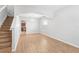 Open living area with wood-look floors and staircase at 13174 Royal Pines Ave, Riverview, FL 33579