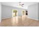 Open-concept living room with tile flooring, fan, and sliding door at 13174 Royal Pines Ave, Riverview, FL 33579