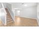 Bright, open-concept living room features wood floors, neutral paint, and staircase to the second floor at 13174 Royal Pines Ave, Riverview, FL 33579
