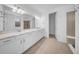 Bathroom featuring dual sinks, white cabinets, quartz counters, and tile floor at 13855 Sharp Hawk Dr, Riverview, FL 33569