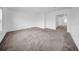 An empty bedroom with a large window and carpet, with a hallway view at 13855 Sharp Hawk Dr, Riverview, FL 33569