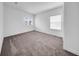 Bright bedroom with neutral carpet, white walls, and natural light from two windows at 13855 Sharp Hawk Dr, Riverview, FL 33569