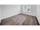 A small bedroom with carpet and a window at 13855 Sharp Hawk Dr, Riverview, FL 33569